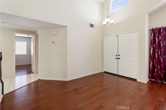 6879 Mission Grove Pkwy N, Riverside, CA 92506 - foyer featuring wood finished floors, a chandelier, and a towering ceiling