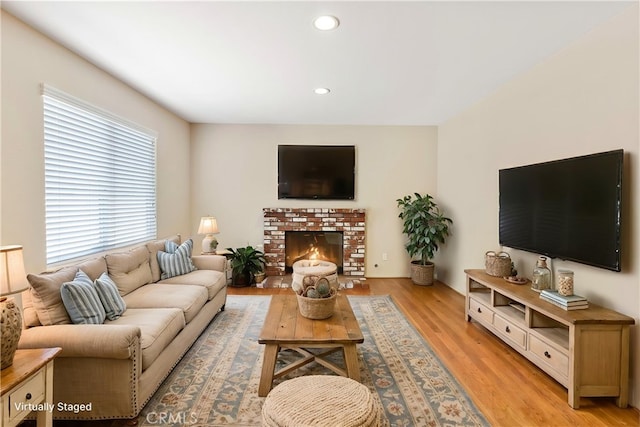 6879 Mission Grove Pkwy N, Riverside, CA 92506 - living area featuring light wood-type flooring, recessed lighting, and a brick fireplace