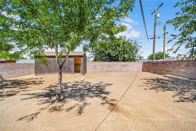 37858 10th St E, Palmdale, CA 93550 - fenced backyard with a storage unit and a patio area