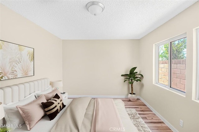 37858 10th St E, Palmdale, CA 93550 - bedroom with light wood-style floors and a textured ceiling