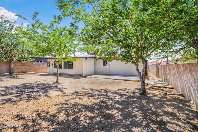 37858 10th St E, Palmdale, CA 93550 - rear view of property featuring a fenced backyard, stucco siding, and a patio area