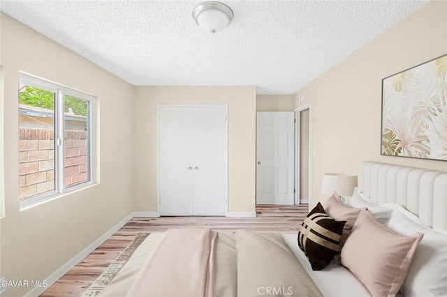 37858 10th St E, Palmdale, CA 93550 - bedroom with light wood finished floors, a textured ceiling, and a closet