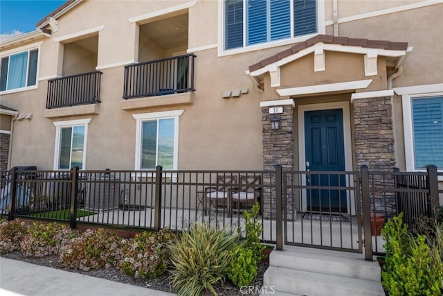 16540 Wyndham Ln Unit 10, Fontana, CA 92336 - property entrance featuring stucco siding and stone siding