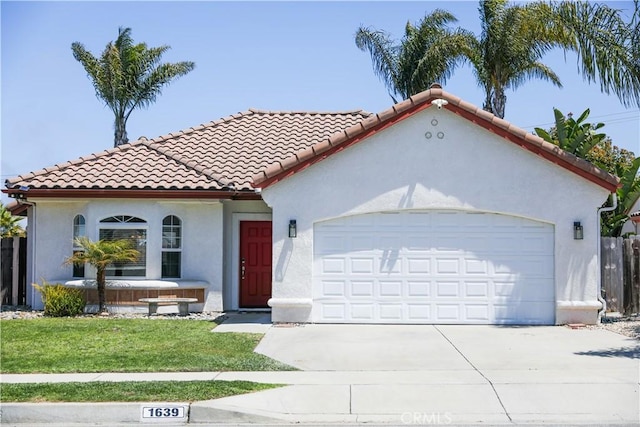 1639 La Selva Ave, Grover Beach, CA 93433 - mediterranean / spanish-style house with a garage, concrete driveway, stucco siding, a front yard, and a tile roof