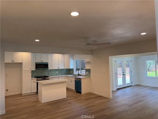 208 S Gaffney Ave, San Dimas, CA 91773 - kitchen with dishwasher, white cabinetry, wood finished floors, french doors, and light countertops