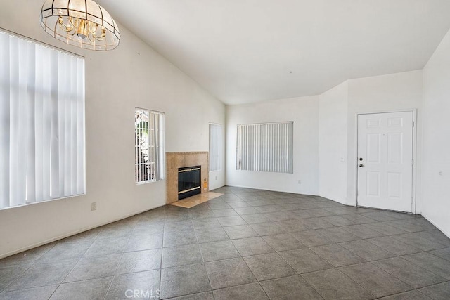 16205 Seville Ave, Fontana, CA 92335 - unfurnished living room with a chandelier, a high end fireplace, high vaulted ceiling, and tile patterned flooring