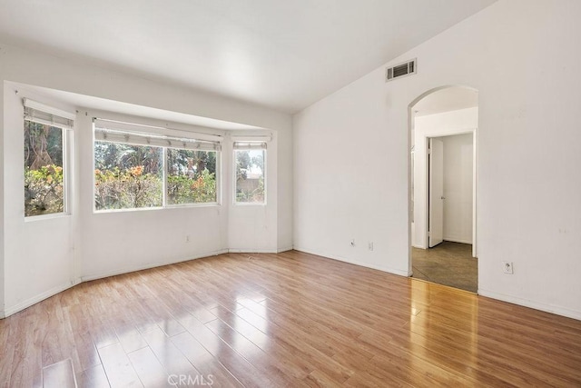 16205 Seville Ave, Fontana, CA 92335 - unfurnished room with arched walkways, lofted ceiling, and wood finished floors