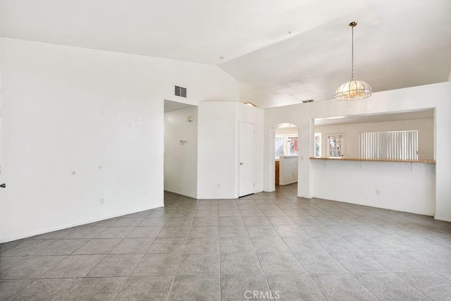 16205 Seville Ave, Fontana, CA 92335 - unfurnished living room featuring lofted ceiling, arched walkways, and light tile patterned floors