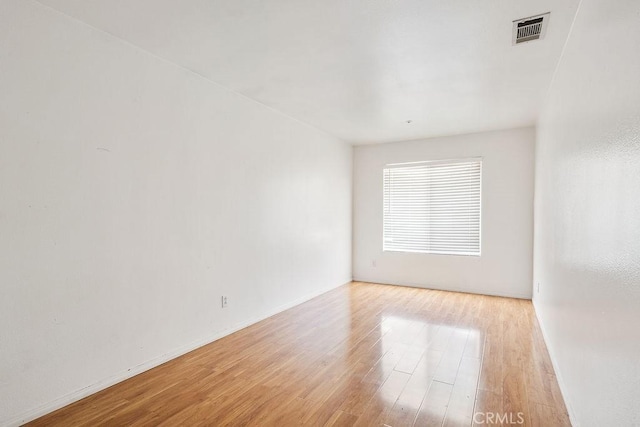 16205 Seville Ave, Fontana, CA 92335 - empty room with light wood finished floors and baseboards