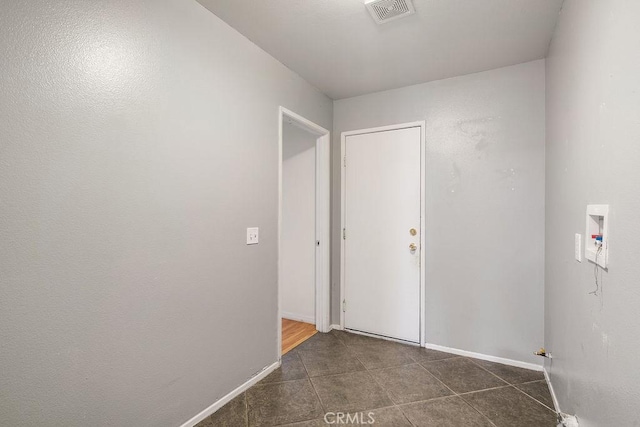 16205 Seville Ave, Fontana, CA 92335 - washroom featuring washer hookup and dark tile patterned floors