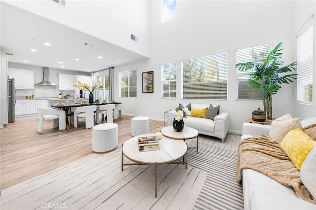 16471 Globetrotter St, Chino, CA 91708 - living room with light wood-type flooring, healthy amount of natural light, recessed lighting, and a towering ceiling