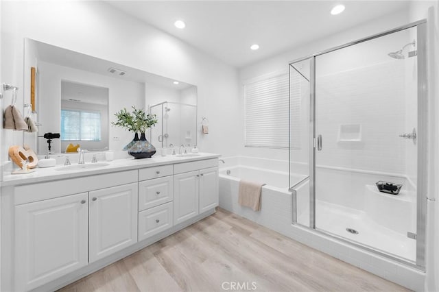 16471 Globetrotter St, Chino, CA 91708 - full bath featuring a stall shower, a garden tub, double vanity, wood finished floors, and recessed lighting