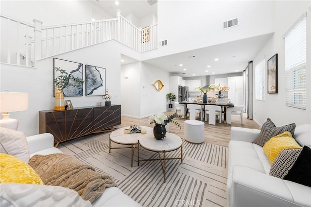 16471 Globetrotter St, Chino, CA 91708 - living area with a towering ceiling and light wood-type flooring