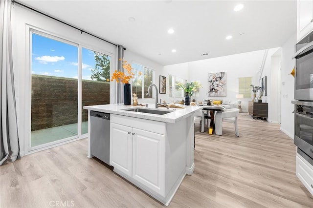 16471 Globetrotter St, Chino, CA 91708 - kitchen with stainless steel dishwasher, light countertops, recessed lighting, white cabinetry, and light wood-type flooring