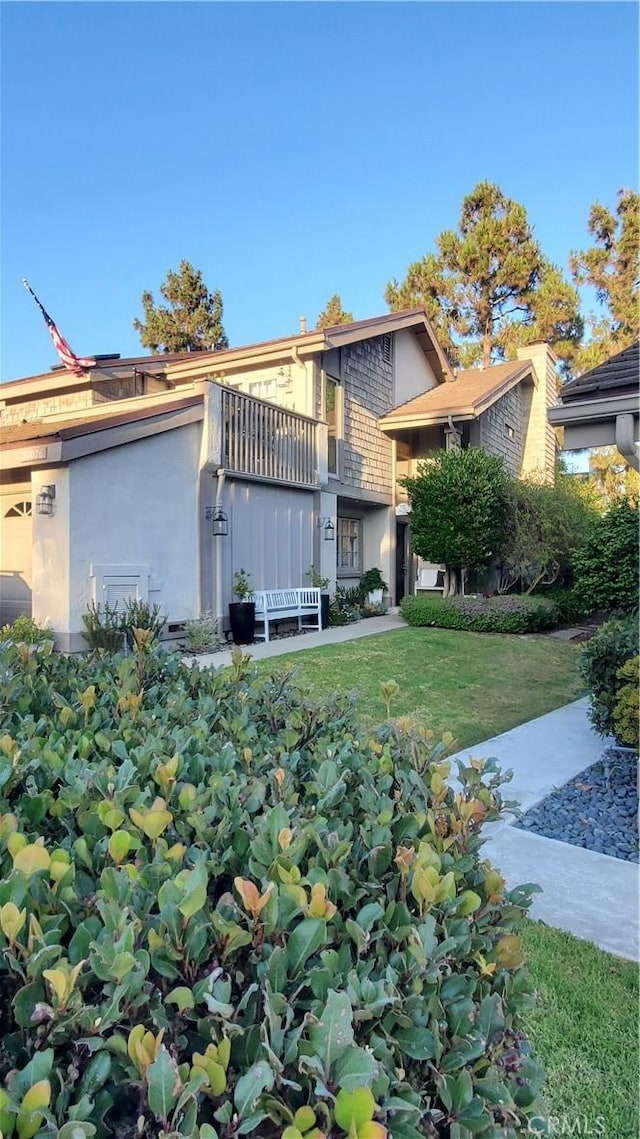 27076 Mill Pond Rd W Unit 9, Dana Point, CA 92624 - view of front of property with a front lawn and stucco siding