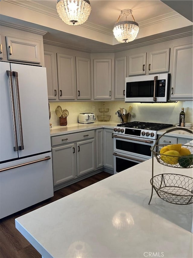 27076 Mill Pond Rd W Unit 9, Dana Point, CA 92624 - kitchen featuring high end fridge, double oven range, light countertops, dark wood-style flooring, and crown molding