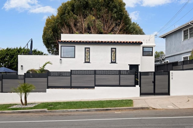 608 Forward St, La Jolla, CA 92037 - view of front facade featuring a gate, a fenced front yard, stucco siding, and a tile roof