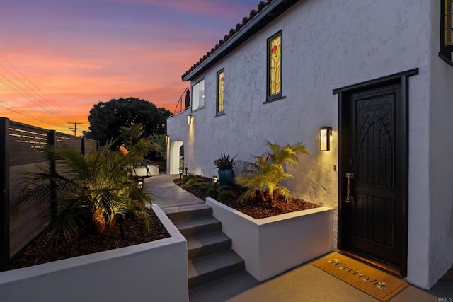 608 Forward St, La Jolla, CA 92037 - exterior entry at dusk featuring stucco siding and a tile roof