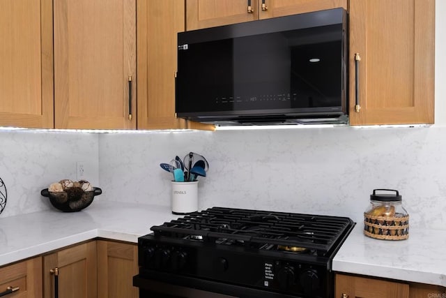 608 Forward St, La Jolla, CA 92037 - kitchen featuring black microwave, stove, backsplash, and light countertops