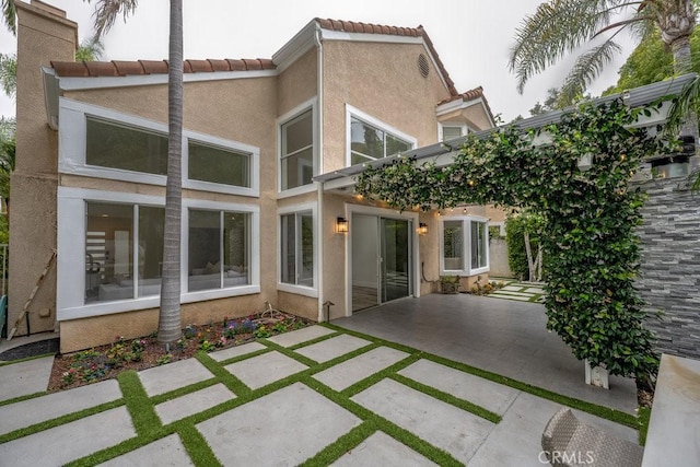 24523 Via Esquina, Calabasas, CA 91302 - back of house featuring a patio, stucco siding, and a tile roof