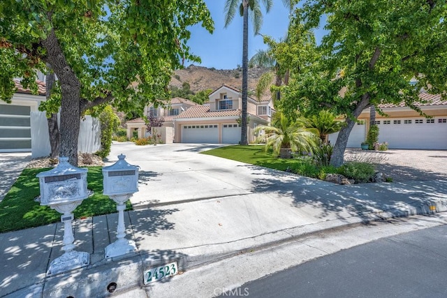 24523 Via Esquina, Calabasas, CA 91302 - view of front of property with driveway, a tile roof, a mountain view, and stucco siding