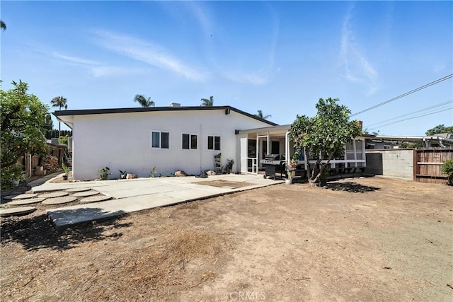 951 W Olive St, Corona, CA 92882 - rear view of property with a patio, stucco siding, and a sunroom