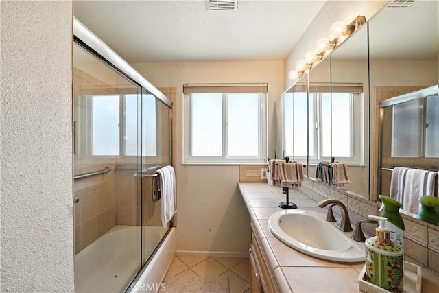 951 W Olive St, Corona, CA 92882 - bathroom featuring vanity, tile patterned floors, and combined bath / shower with glass door