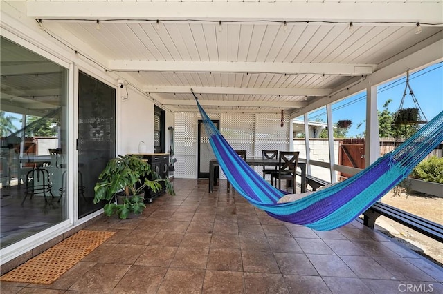 951 W Olive St, Corona, CA 92882 - sunroom featuring healthy amount of natural light, outdoor dining area, and beamed ceiling