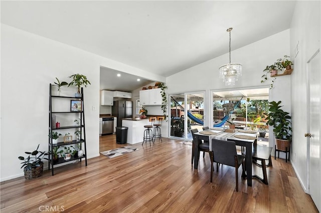 951 W Olive St, Corona, CA 92882 - dining room with light wood-type flooring, a chandelier, and high vaulted ceiling