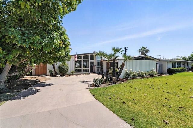 951 W Olive St, Corona, CA 92882 - view of front of home featuring driveway and a sunroom