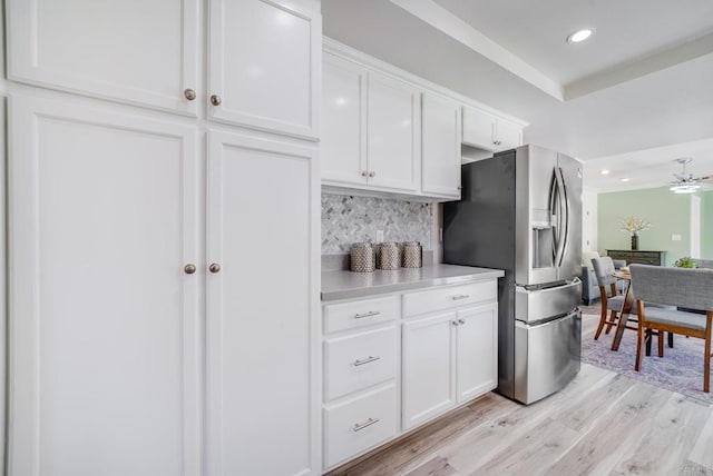 15020 Penasquitos Dr, Rancho Penasquitos, CA 92129 - kitchen with stainless steel fridge with ice dispenser, white cabinets, decorative backsplash, recessed lighting, and light wood-style floors