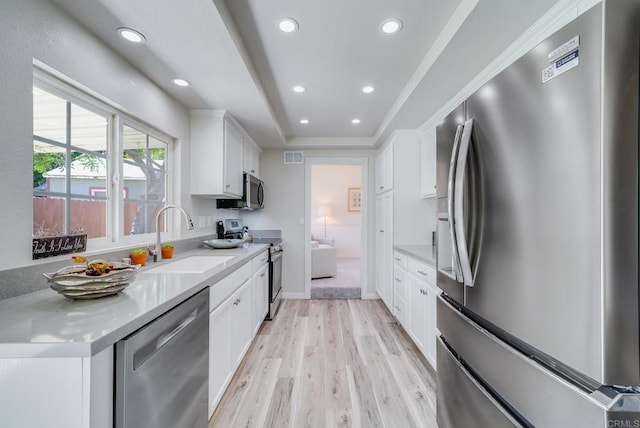 15020 Penasquitos Dr, Rancho Penasquitos, CA 92129 - kitchen featuring appliances with stainless steel finishes, recessed lighting, light wood-style floors, white cabinets, and light countertops