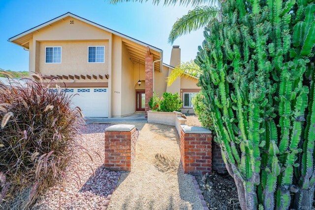 15020 Penasquitos Dr, Rancho Penasquitos, CA 92129 - view of front facade featuring stucco siding and a chimney