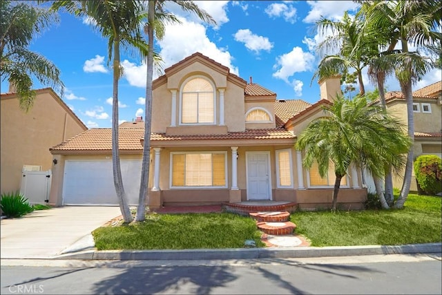 13 Santa Monica St, Aliso Viejo, CA 92656 - mediterranean / spanish-style house featuring stucco siding, a tile roof, concrete driveway, and a garage