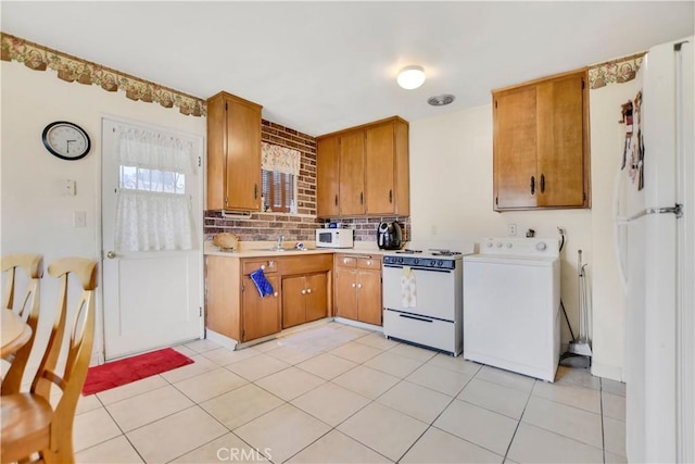 1582 Hardt St, San Bernardino, CA 92408 - kitchen with white appliances, washer / dryer, light countertops, decorative backsplash, and light tile patterned floors