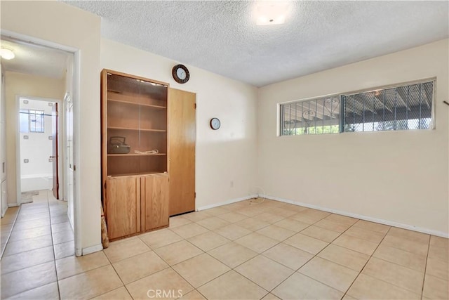 1582 Hardt St, San Bernardino, CA 92408 - empty room with a textured ceiling and light tile patterned flooring