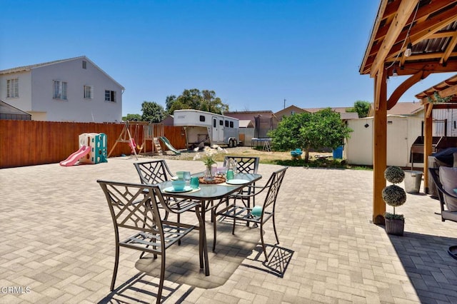 208 S 4th St, Santa Paula, CA 93060 - fenced backyard featuring a trampoline, a playground, a storage shed, a patio, and outdoor dining space
