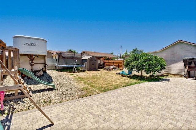 208 S 4th St, Santa Paula, CA 93060 - view of yard featuring a storage unit, a playground, a trampoline, and a patio