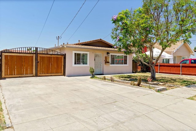 208 S 4th St, Santa Paula, CA 93060 - view of front of house featuring stucco siding, concrete driveway, and a gate