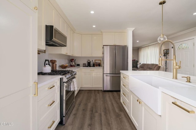 208 S 4th St, Santa Paula, CA 93060 - kitchen with appliances with stainless steel finishes, light countertops, dark wood-style flooring, recessed lighting, and crown molding