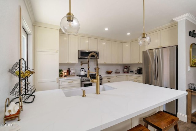 208 S 4th St, Santa Paula, CA 93060 - kitchen with appliances with stainless steel finishes, a kitchen breakfast bar, light countertops, decorative light fixtures, and recessed lighting