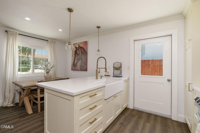 208 S 4th St, Santa Paula, CA 93060 - kitchen with dark wood-style floors, decorative light fixtures, a peninsula, light countertops, and crown molding