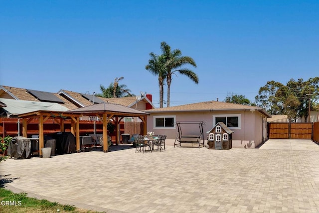 208 S 4th St, Santa Paula, CA 93060 - back of house with a gazebo, a patio, stucco siding, outdoor dining space, and a gate