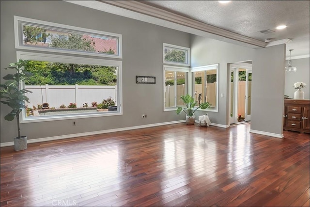 25225 Avenida Tranquila, Lake Forest, CA 92630 - unfurnished living room with a textured ceiling, ornamental molding, and dark wood-style floors