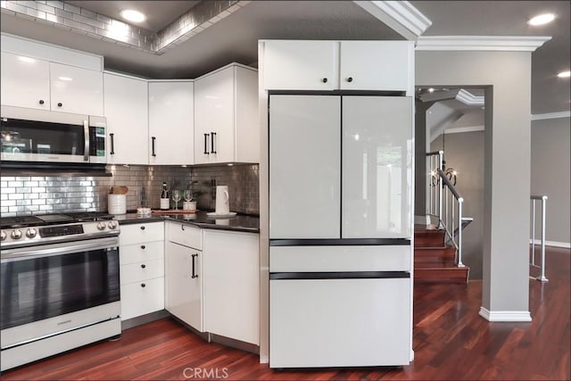 25225 Avenida Tranquila, Lake Forest, CA 92630 - kitchen featuring appliances with stainless steel finishes, ornamental molding, dark wood-style floors, decorative backsplash, and dark countertops