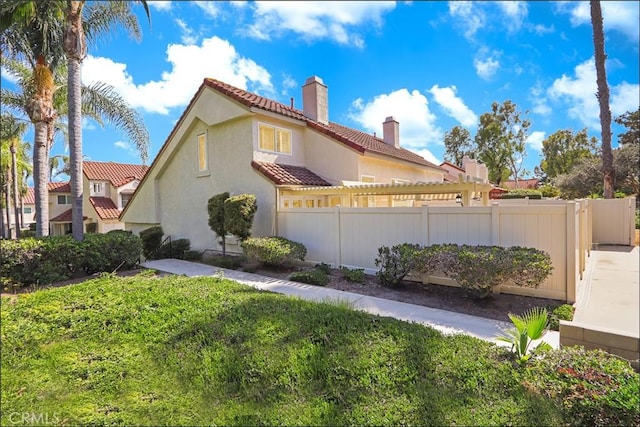 25225 Avenida Tranquila, Lake Forest, CA 92630 - view of property exterior featuring a chimney, stucco siding, and a tile roof