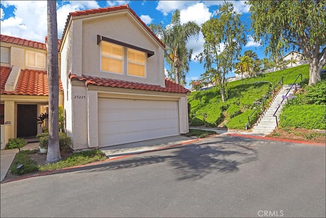 25225 Avenida Tranquila, Lake Forest, CA 92630 - view of front of property with a tiled roof, stucco siding, and stairway