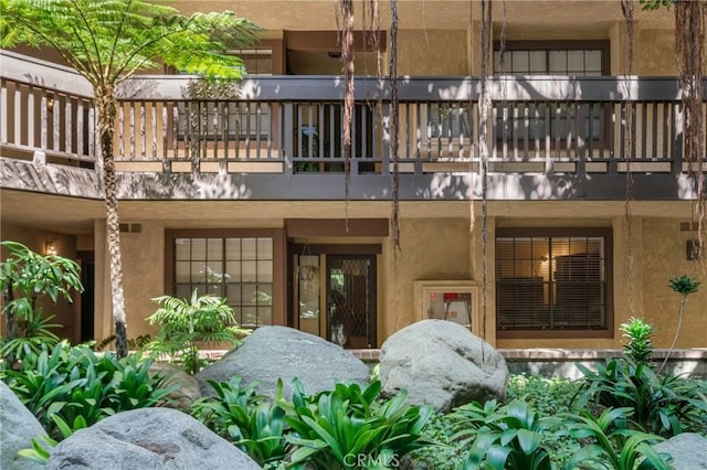 1645 Clark Ave Unit 115, Long Beach, CA 90815 - rear view of property with a balcony and stucco siding