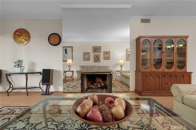 1645 Clark Ave Unit 115, Long Beach, CA 90815 - living area with crown molding, wood finished floors, and a tiled fireplace