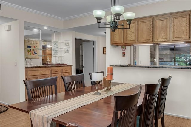 1645 Clark Ave Unit 115, Long Beach, CA 90815 - dining area with a chandelier, bar with sink, light wood-type flooring, and ornamental molding